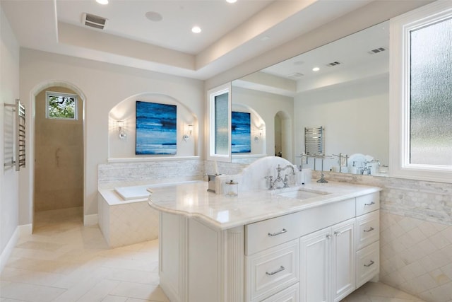 212 Bella Cima Dr, Austin, TX 78734 - full bath featuring a tray ceiling, a towel warmer, a garden tub, vanity, and tile patterned flooring