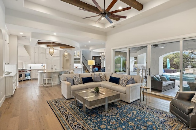 212 Bella Cima Dr, Austin, TX 78734 - living room featuring a ceiling fan, beam ceiling, light wood-style floors, coffered ceiling, and stairway