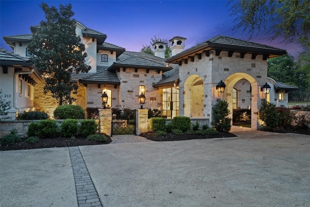 212 Bella Cima Dr, Austin, TX 78734 - view of front of property with stone siding, a gate, and a tile roof