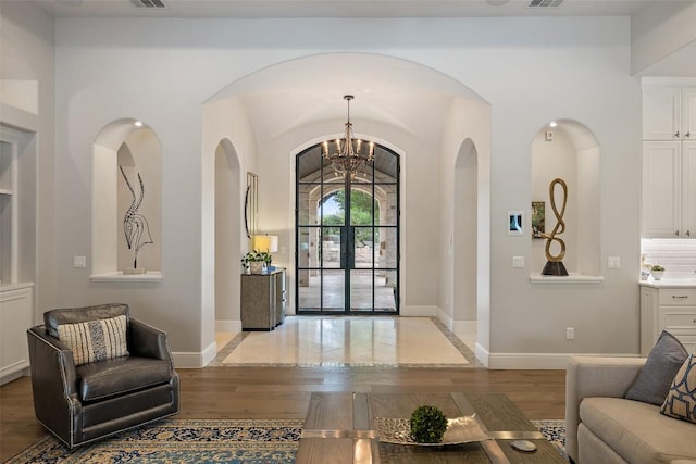 212 Bella Cima Dr, Austin, TX 78734 - foyer entrance featuring light wood-style floors, arched walkways, and a chandelier