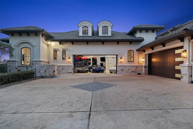 212 Bella Cima Dr, Austin, TX 78734 - view of front of home featuring driveway, stone siding, a garage, and stucco siding