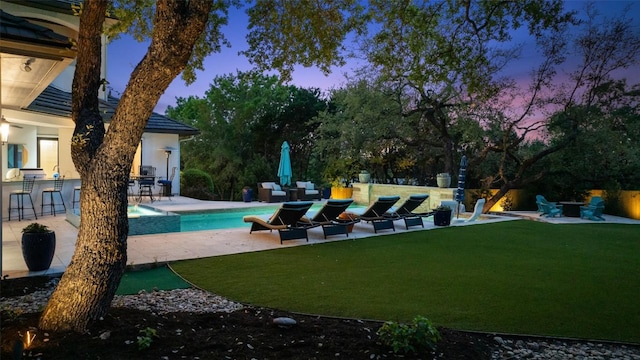 212 Bella Cima Dr, Austin, TX 78734 - pool at dusk with a patio, a yard, and a pool with connected hot tub