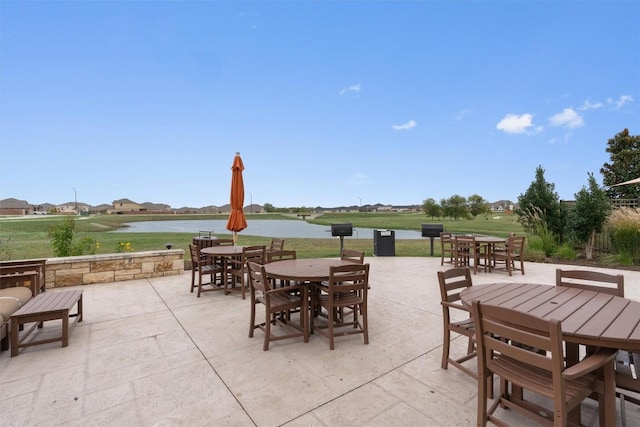 view of patio / terrace featuring a water view and outdoor dining area