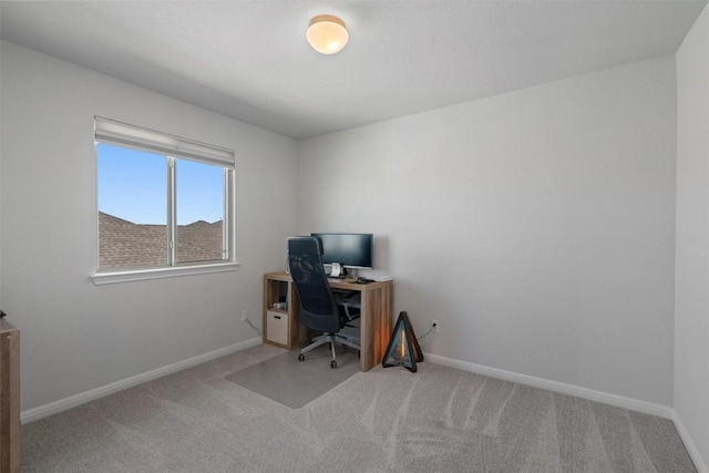office area featuring baseboards and carpet