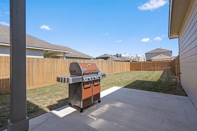 view of patio featuring a fenced backyard and a grill