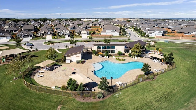 pool with fence and a residential view