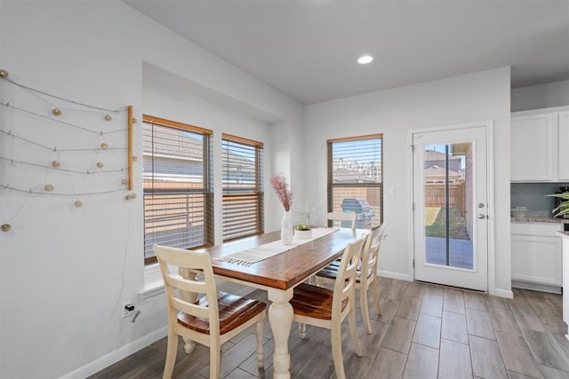 dining room with light wood-style floors, baseboards, and recessed lighting