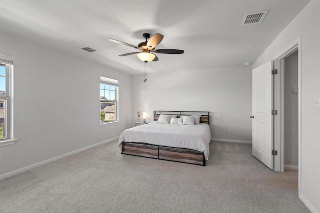 carpeted bedroom featuring visible vents, a ceiling fan, and baseboards