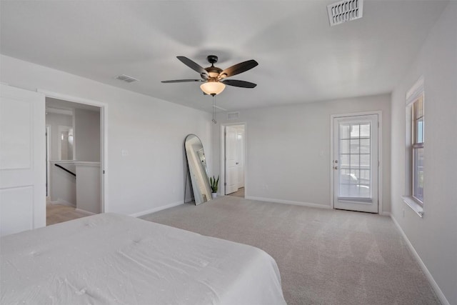 bedroom featuring baseboards, light colored carpet, and visible vents