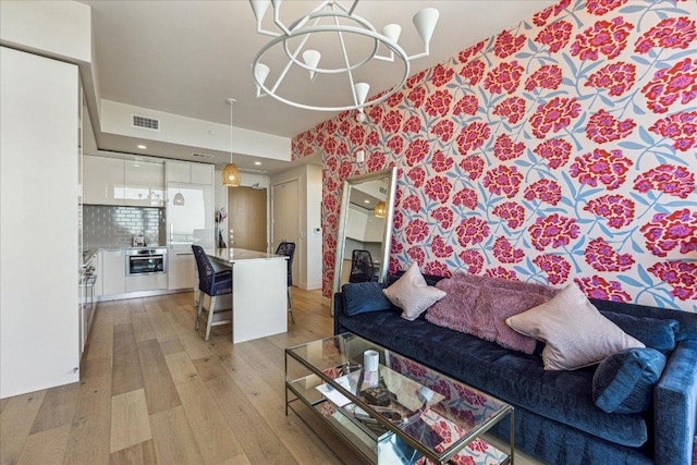 44 E Ave Unit 2509, Austin, TX 78701 - living room featuring light wood-type flooring and wallpapered walls