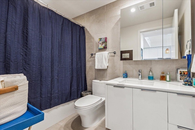 44 E Ave Unit 2509, Austin, TX 78701 - full bathroom with tile walls, vanity, and tile patterned flooring