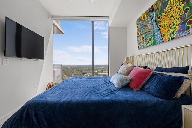 44 E Ave Unit 2509, Austin, TX 78701 - bedroom featuring multiple windows and floor to ceiling windows
