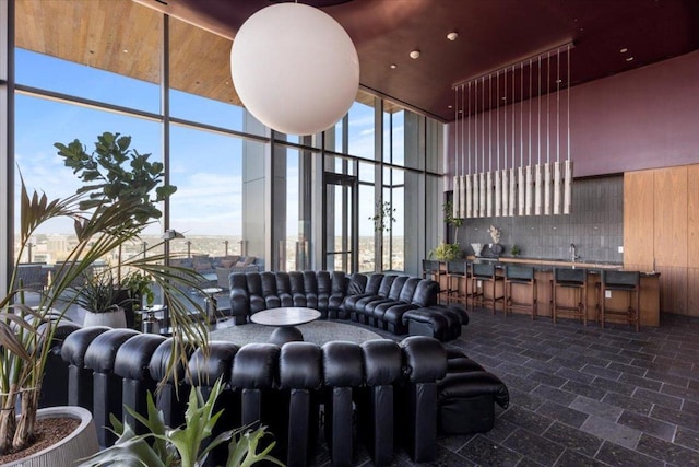 44 E Ave Unit 2509, Austin, TX 78701 - living area with a towering ceiling, a wall of windows, and stone finish flooring