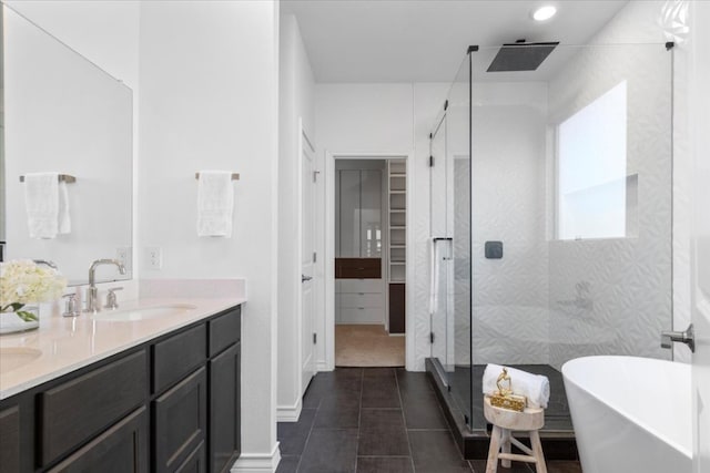 1007 Sandra Ann Way, Hutto, TX 78634 - full bath featuring a stall shower, a freestanding tub, double vanity, tile patterned flooring, and a closet