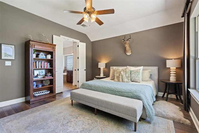 577 Shelf Rock Rd, Driftwood, TX 78619 - bedroom featuring baseboards, wood finished floors, lofted ceiling, a ceiling fan, and connected bathroom