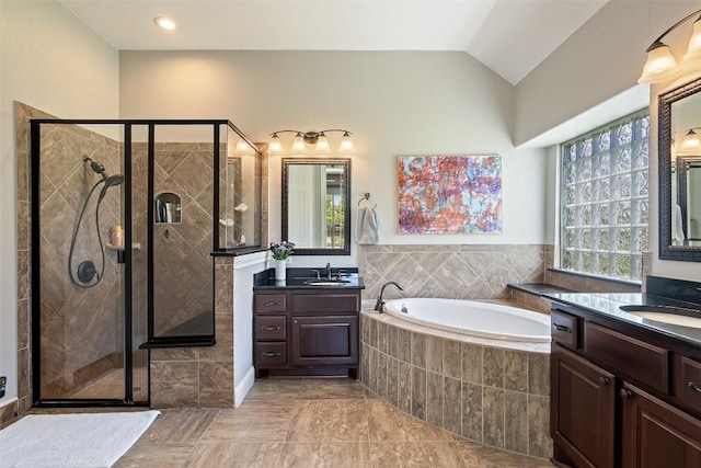 577 Shelf Rock Rd, Driftwood, TX 78619 - bathroom featuring a stall shower, a garden tub, two vanities, lofted ceiling, and tile patterned flooring