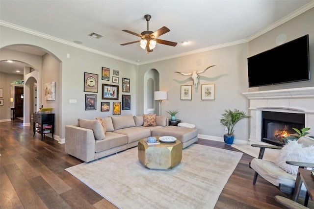 577 Shelf Rock Rd, Driftwood, TX 78619 - living area with arched walkways, dark wood-style floors, ornamental molding, and a ceiling fan