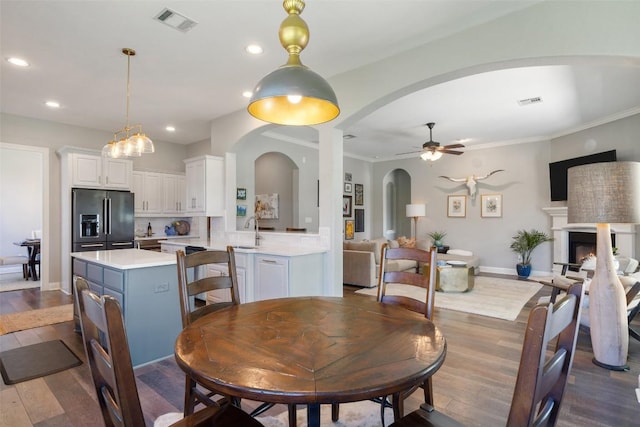 577 Shelf Rock Rd, Driftwood, TX 78619 - dining space with arched walkways, recessed lighting, a ceiling fan, dark wood finished floors, and baseboards