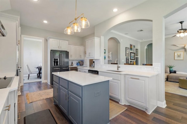 577 Shelf Rock Rd, Driftwood, TX 78619 - kitchen with high quality fridge, arched walkways, white cabinets, a kitchen island, and dark wood-type flooring