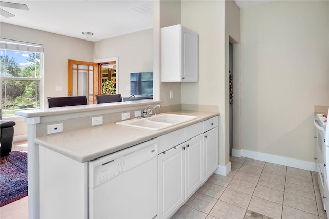 119 Maple Leaf Trl, Elgin, TX 78621 - kitchen featuring white dishwasher, white cabinetry, light countertops, a peninsula, and light tile patterned flooring