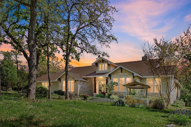 119 Maple Leaf Trl, Elgin, TX 78621 - craftsman-style home featuring stone siding, a chimney, a shingled roof, and a front lawn