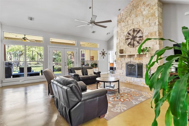 119 Maple Leaf Trl, Elgin, TX 78621 - living room with ceiling fan, french doors, a stone fireplace, high vaulted ceiling, and finished concrete flooring