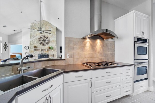 119 Maple Leaf Trl, Elgin, TX 78621 - kitchen with appliances with stainless steel finishes, ventilation hood, lofted ceiling, dark countertops, and ceiling fan
