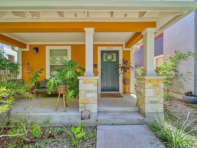doorway to property featuring covered porch