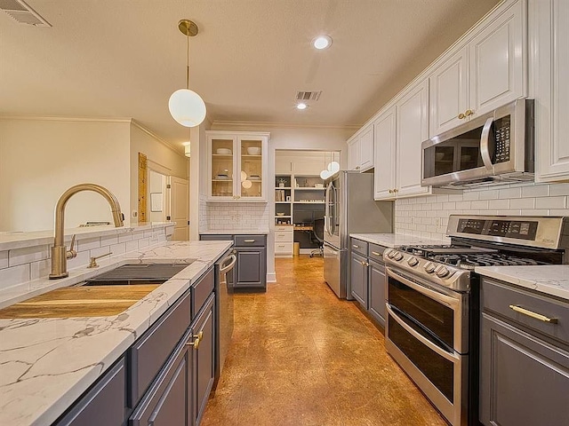 kitchen with white cabinets, visible vents, a sink, stainless steel appliances, and gray cabinetry