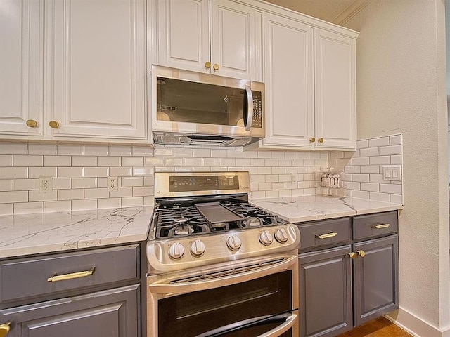 kitchen featuring gray cabinets, tasteful backsplash, appliances with stainless steel finishes, and white cabinets