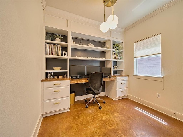office area with built in desk, ornamental molding, baseboards, and built in shelves