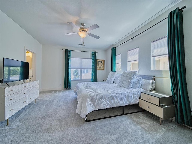 carpeted bedroom featuring ceiling fan, baseboards, and visible vents