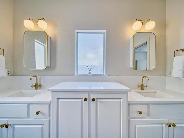 bathroom with a sink and two vanities