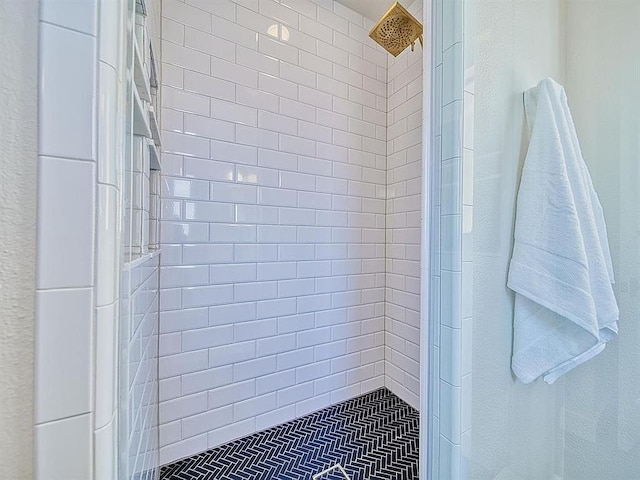 bathroom with a tile shower