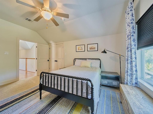 bedroom with baseboards, carpet flooring, a ceiling fan, visible vents, and lofted ceiling