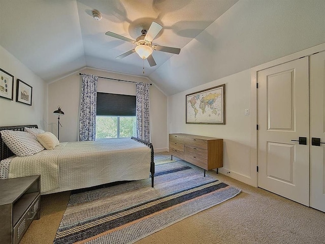 bedroom with carpet floors, ceiling fan, vaulted ceiling, and baseboards