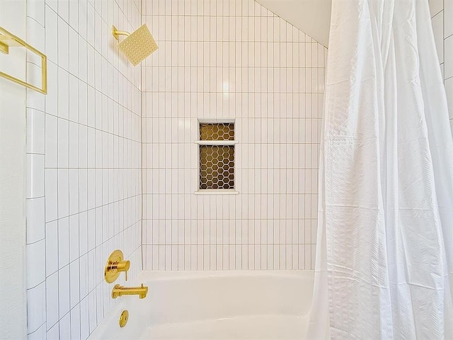 bathroom with shower / bath combination with curtain