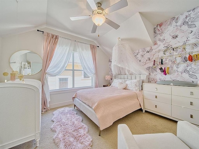 bedroom featuring wallpapered walls, baseboards, light colored carpet, and vaulted ceiling