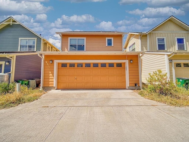 traditional-style house with an attached garage and driveway