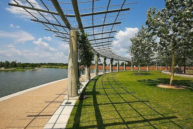 view of home's community featuring a water view and a lawn
