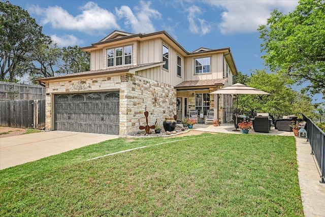 view of front facade featuring fence, stone siding, concrete driveway, a front yard, and board and batten siding