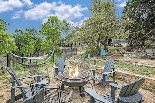 view of patio / terrace featuring a fire pit and fence