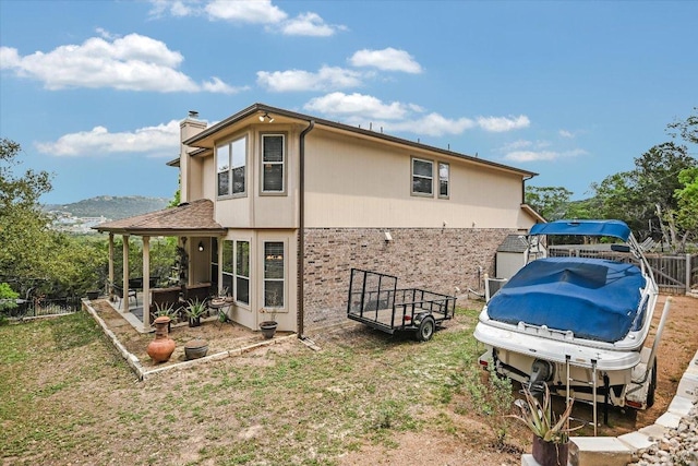 7404 Little Oak Cir, Lago Vista, TX 78645 - view of side of home with brick siding, a chimney, and a carport