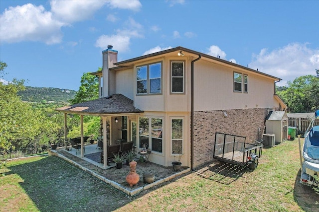 7404 Little Oak Cir, Lago Vista, TX 78645 - rear view of house featuring a chimney, a patio, a shed, and brick siding