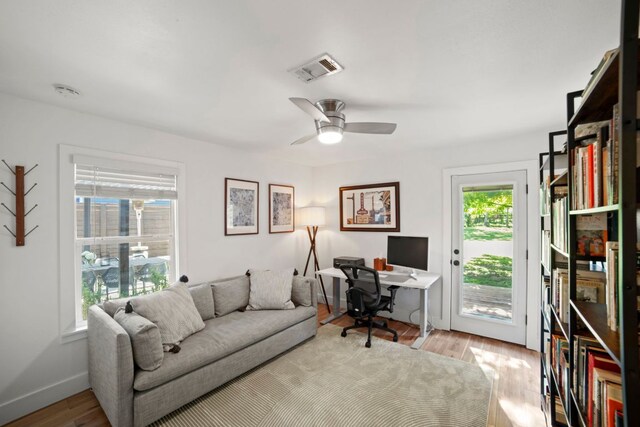 6009 Grover Ave, Austin, TX 78757 - home office featuring wood finished floors, a ceiling fan, and baseboards