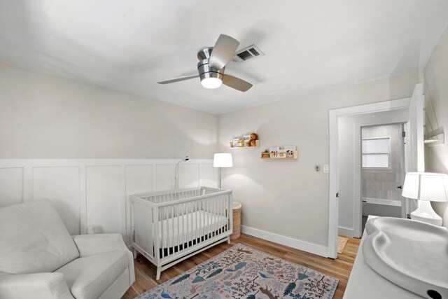 6009 Grover Ave, Austin, TX 78757 - bedroom featuring wood finished floors, a ceiling fan, a sink, and baseboards