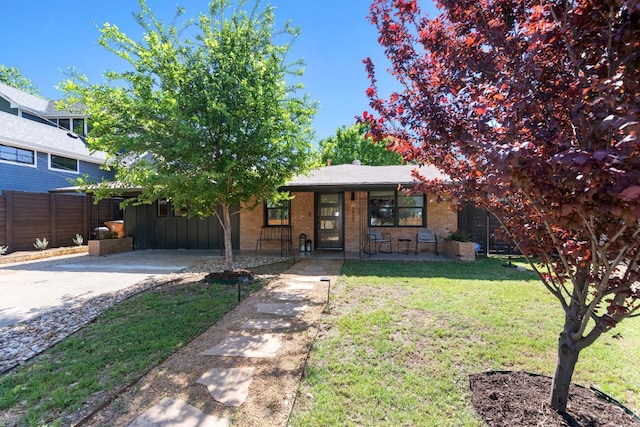 6009 Grover Ave, Austin, TX 78757 - view of front of home featuring a porch, brick siding, and driveway