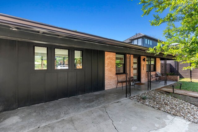 6009 Grover Ave, Austin, TX 78757 - back of house featuring board and batten siding and brick siding