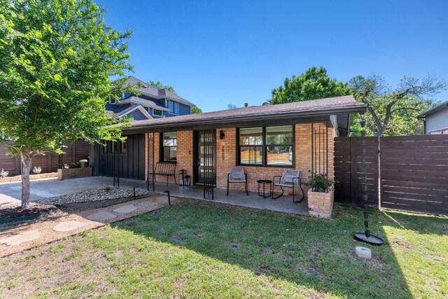 6009 Grover Ave, Austin, TX 78757 - view of front of home with brick siding, board and batten siding, and a porch
