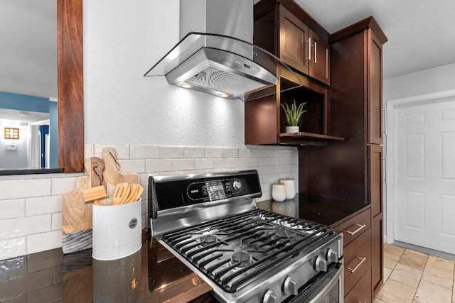 6013 Mountain Villa Dr, Austin, TX 78731 - kitchen with stainless steel gas range, wall chimney exhaust hood, tasteful backsplash, dark countertops, and dark brown cabinetry